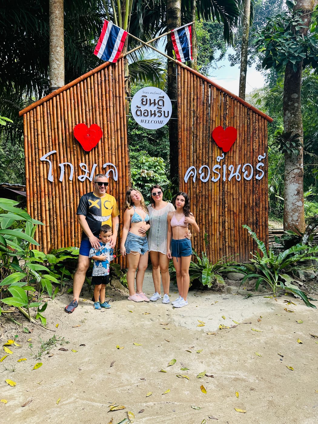 Family at a tropical welcome photo spot