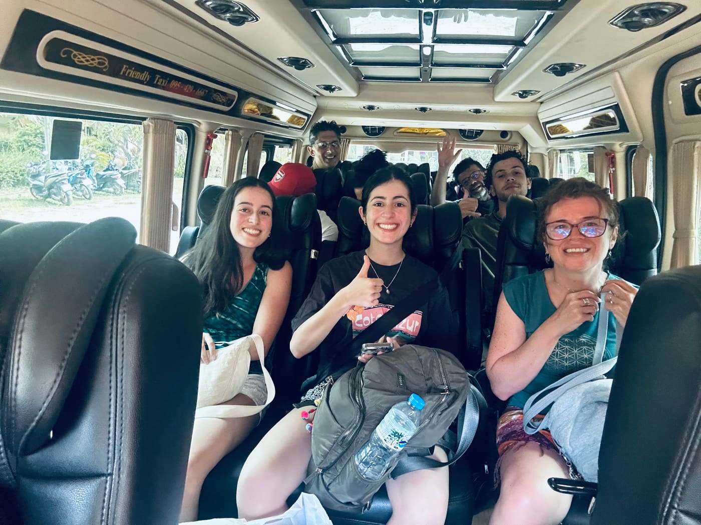 Happy guests in a Friendly Taxi van